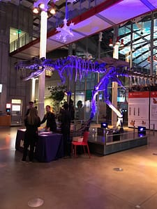 Corporate holiday party for Marketo at The California Academy of Sciences with Marketo purple uplighting surrounding Tyrannosaurus Rex.